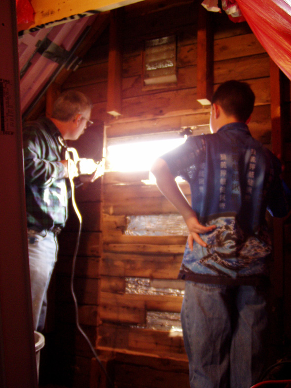 Since we've decided to push on, cutting through rather than removing the siding, we've made our first opening.