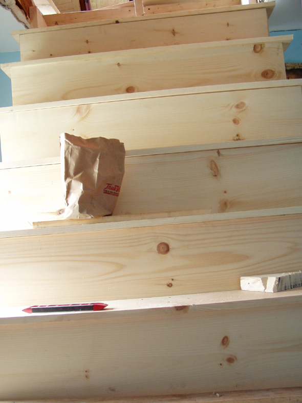 The stair isn't really tilted to the left. Apparently the camera is.