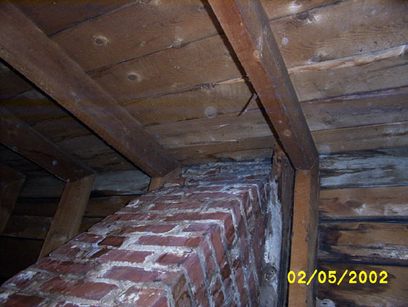A close up of the active chimney on the south side of the attic shows the obvious water stains indicative of a roofing problem.