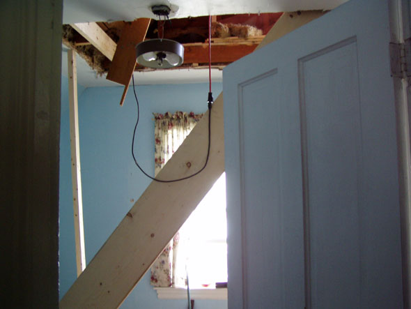 Just a view of the hole from the closet door. It's going to be a little tight gaining access to the stairs, and it'll take up a bit of our closet space, but it seems to be the best alternative. We had considered pull-down stairs, but since we'll be using the attic as a bedroom for our nephew, that wouldn't be appropriate. Spiral stairs would have worked and perhaps been a better idea, but we decided on a regular stair, thinking that it would be easier.