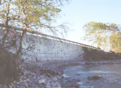 The path along the inside of the Delta Lake bridge is a popular spot for fishing and perhaps a few other things.  This scene is from the east side of the bridge.  If you can ignore the beer bottles and cans, and if you don�t mind the graffiti, this is supposed to be a good spot to fish.