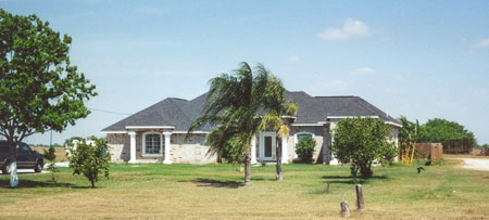 Brick home on N Llano Grande Boulevard and Elia Street.  Llano Grande Boulevard is also known as FM-1015.