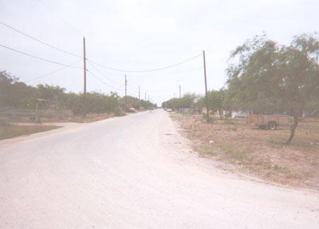 The first of three caliche streets leading east from M 4-W into the Colonia Bernal subdivision.