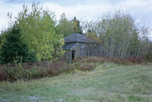An old, deserted home can be seen along Coulombe Road.