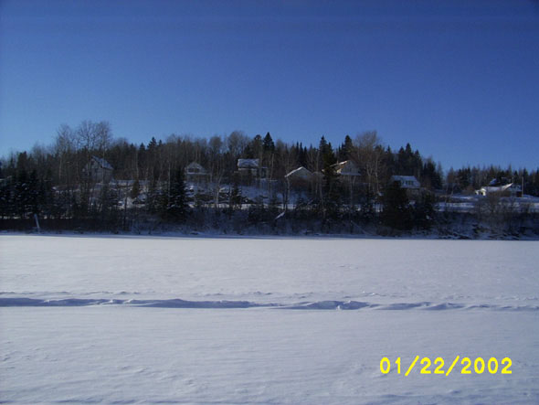 Taken from the southeastern side of the Fish River,  a view of houses along Pond View Drive.